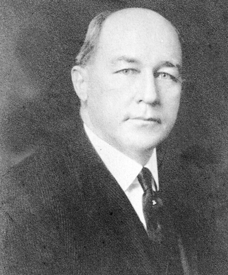 Bald white man in suit and tie
