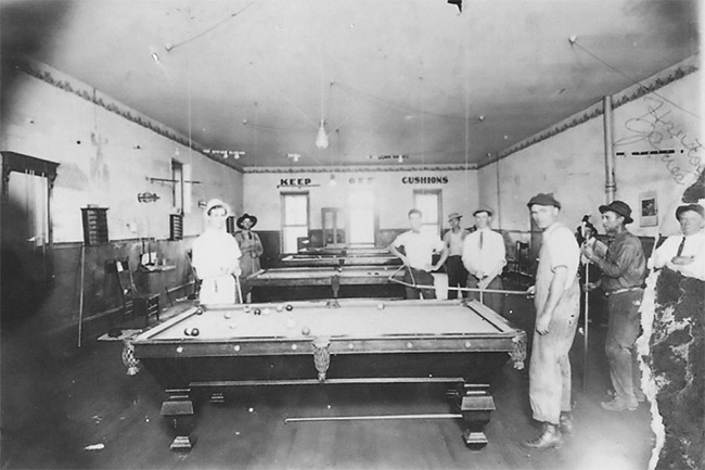 White men and pool tables in pool hall