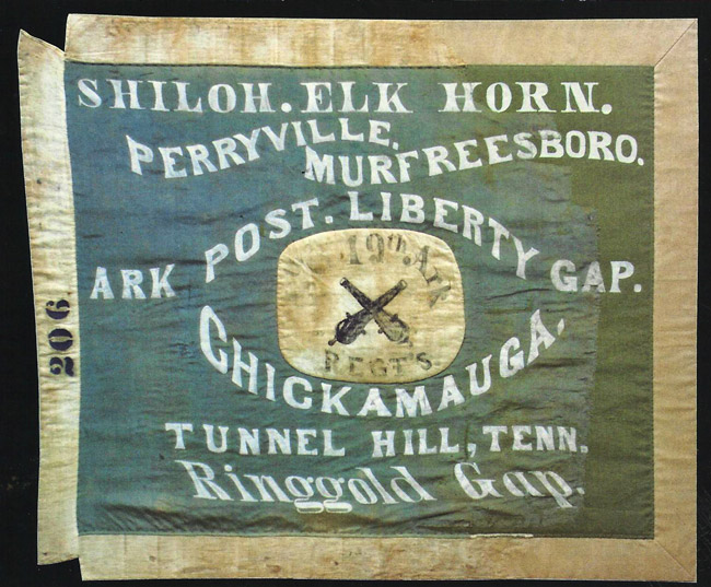 Bluish green and white flag with white text and crossed cannons in the center saying "Shiloh Elk Horn Perryville Murfreesboro Ark Post Liberty Gap Chickamauga Tunnel Hill, Tenn. Ringgold Gap"