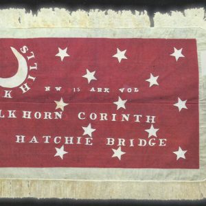 Red flag with white moon and stars and text saying "Oak Hills NW 15 Ark Vol Elkhorn Corinth Hatchie Bridge"