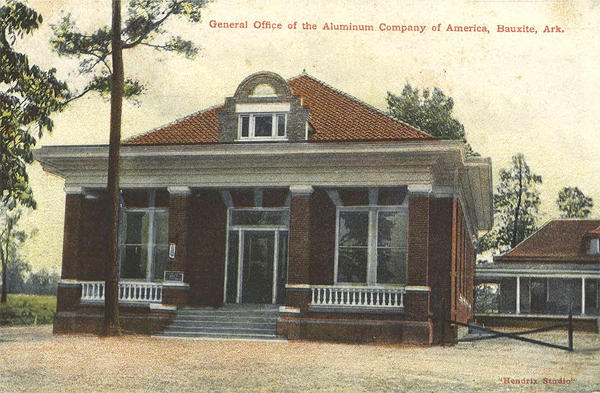 Brick building with covered porch and house on post card