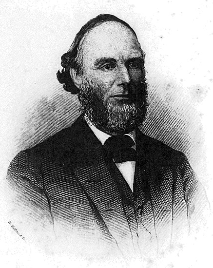 White man with beard in suit and tie