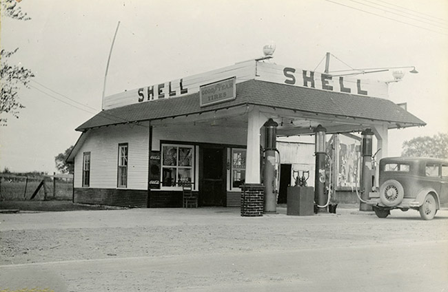 Shell gas station with canopy and gas pumps with car