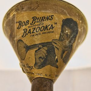 picture of white man playing a bazooka instrument with text printed on bazooka bell