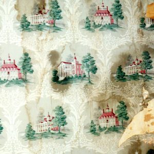 Peeling wallpaper depicting various classical buildings with columns and towers