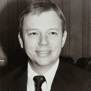 Young white man smiling in suit and tie