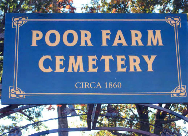 "Poor Farm Cemetery Circa 1860" sign with gold lettering on blue background