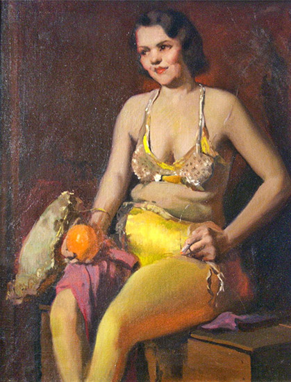 White woman in yellow pants and bra sitting on wooden box with an orange in her left hand and a lit cigarette in her right