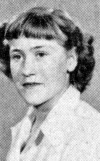 young white woman with wavy hair and bangs cut straight across