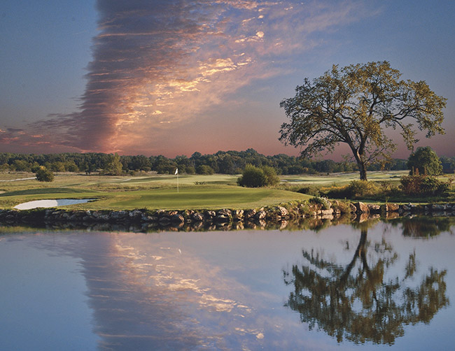 sunset with linear cloud formation over golf course and water hazard