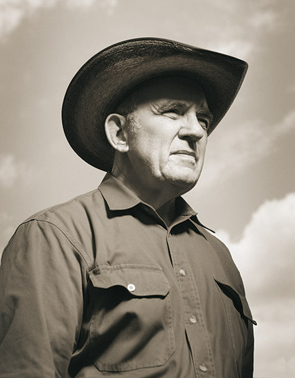 White man in cowboy hat and collared shirt