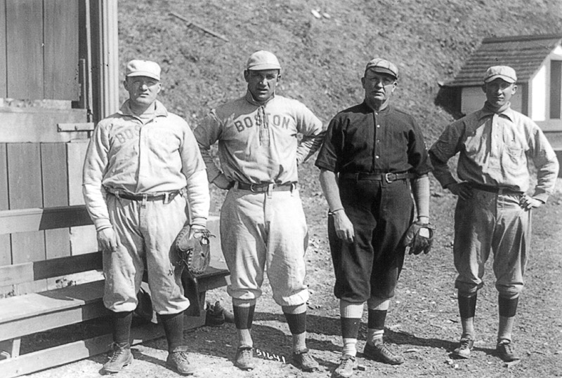 Group of white men in "Boston" baseball uniforms standing in line