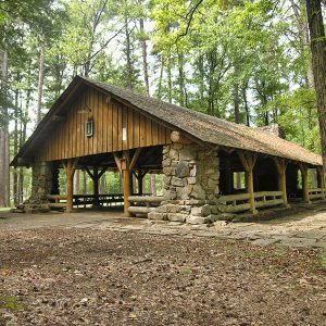 Wood and stone pavilion in forested area