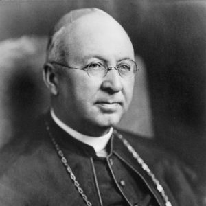 Old white man with round glasses in bishop's robes