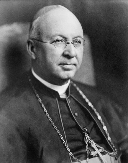Old white man with round glasses in bishop's robes