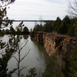Lake with rock wall and trees