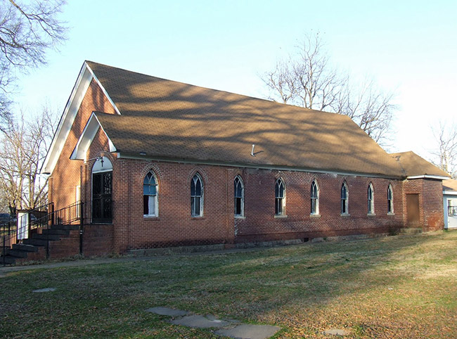 Single-story brick church building with arched windows