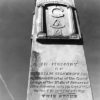 Stone monument with Masonic symbols and funereal inscription