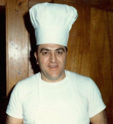 Italian-American man smiling in chef's uniform with hat
