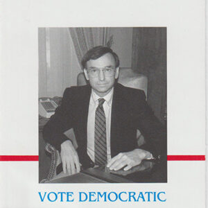 White man in suit sitting in chair on campaign brochure with red and blue text on gray background