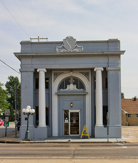 gray two story building with white columns