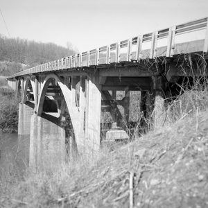 Concrete arch highway bridge over river
