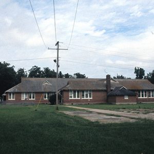 Brick buildings with swing set and power lines