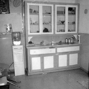 Interior of room with water cooler and cabinets