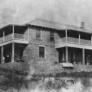 Two-story building with covered porches and balconies
