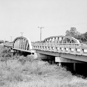 Steel arch bridge with concrete platform and supports