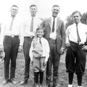 Group of white men and boys in ties standing in group photograph
