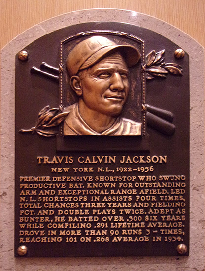 Bust of white man with baseball cap on "Travis Calvin Jackson" plaque