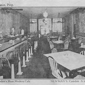 interior of room with bar and tables with chairs on post card with insert of white man in suit