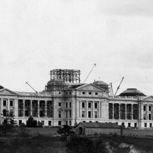 Four-story marble building with dome under construction