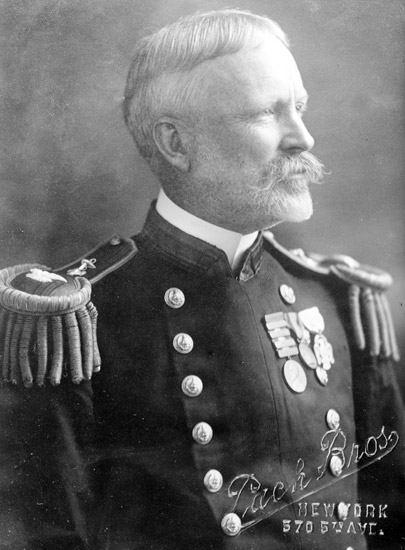 Older white man with mustache in military uniform with medals and epaulets