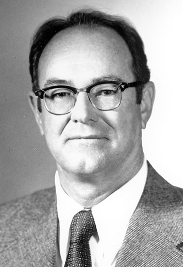 White man with glasses in suit and tie