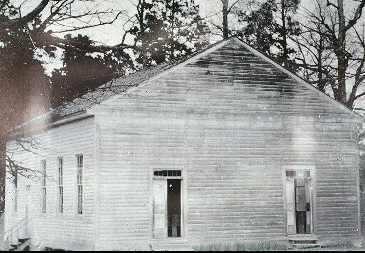 Single-story wooden church building with two front entrances