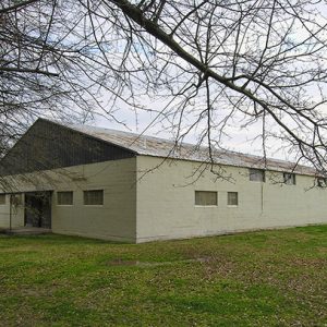 Single-story gymnasium building with covered porch on grass