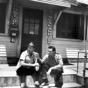 Two white men sitting on the front steps of the Kingsland post office