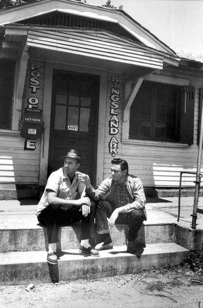 Two white men sitting on the front steps of the Kingsland post office