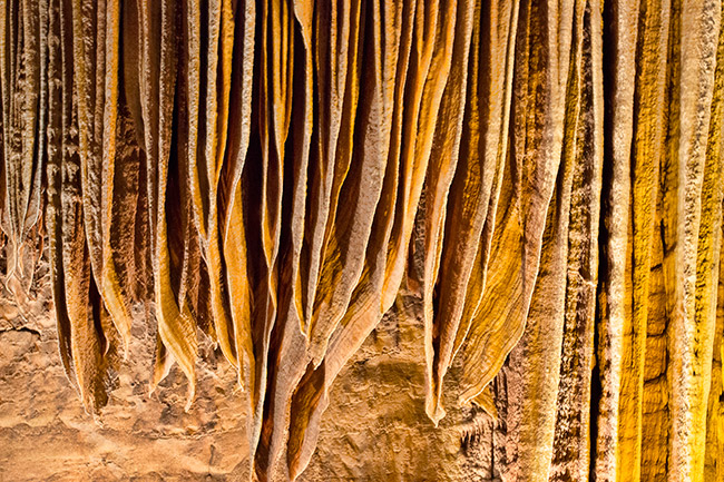 Layered rock features on cave ceiling
