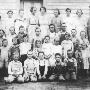 White students and teachers in class photograph