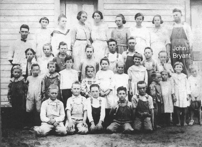 White students and teachers in class photograph