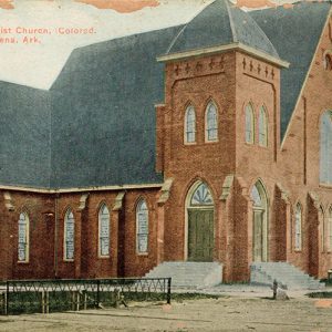 Brick church building with bell tower and gothic arch windows on post card