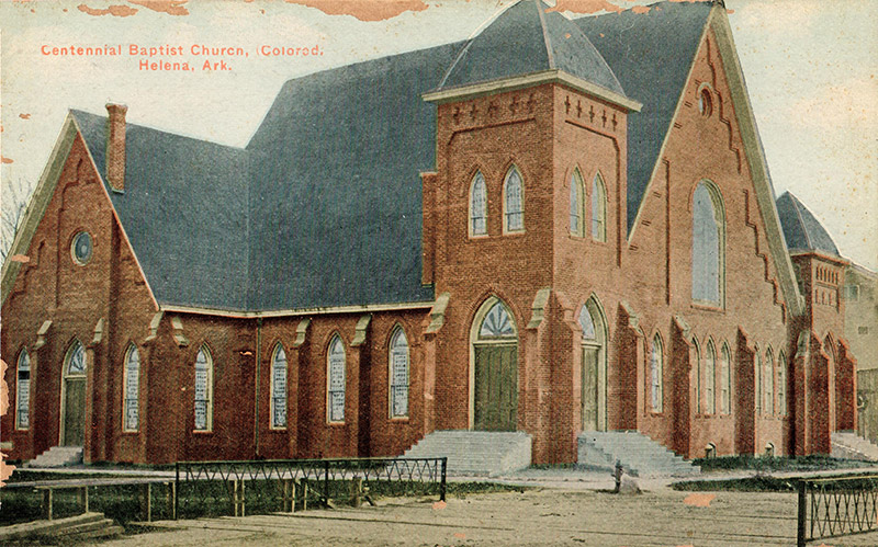 Brick church building with bell tower and gothic arch windows on post card