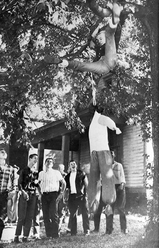 Group of young white men hanging an effigy from a tree