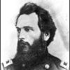 side view of White man with swept-back dark hair and wide beard in military uniform