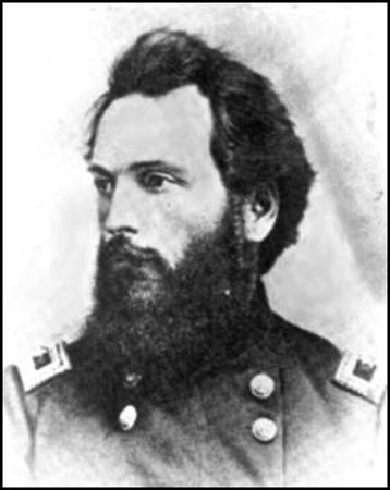 side view of White man with swept-back dark hair and wide beard in military uniform