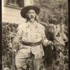 Old white man with long hair and beard in western clothing with hat and gun