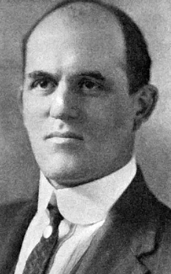 Balding white man in suit and tie